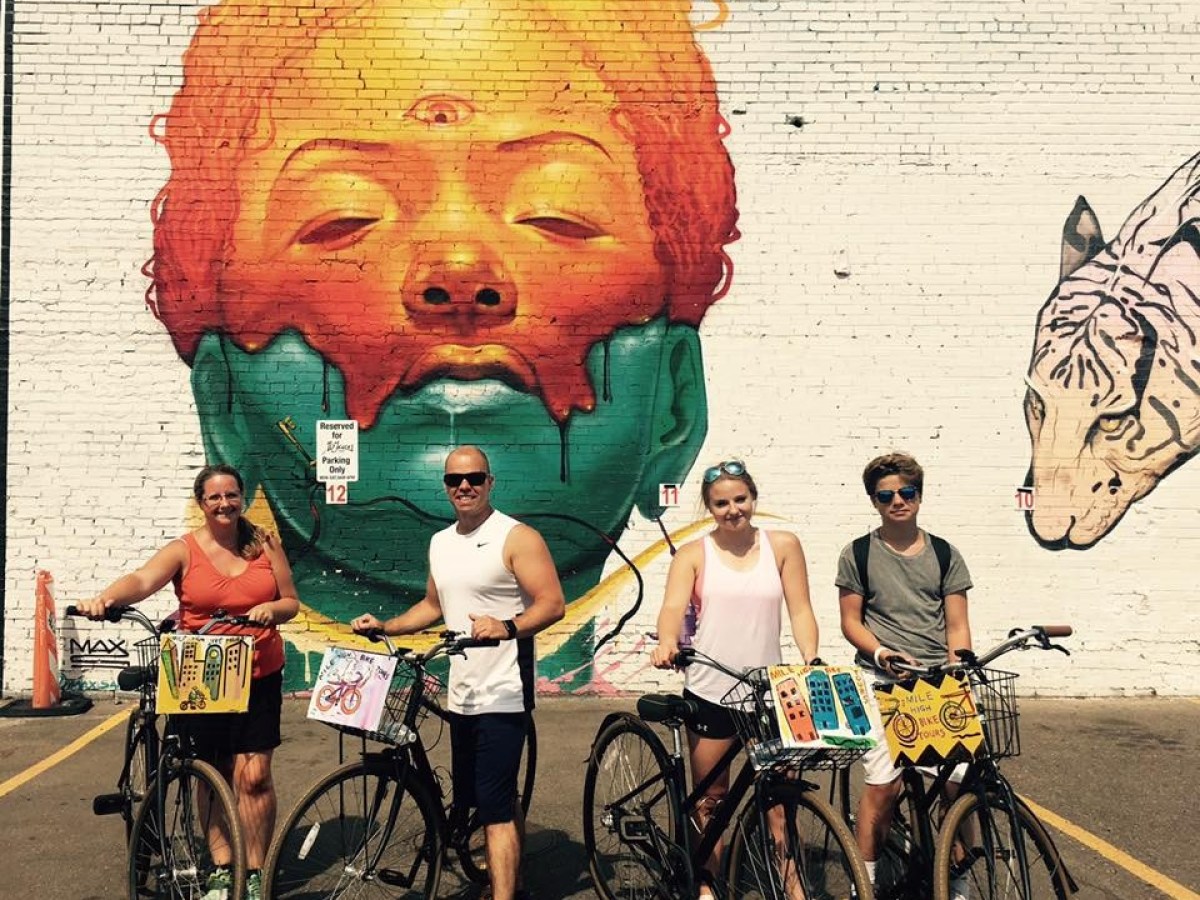 a group of people riding on the back of a bicycle